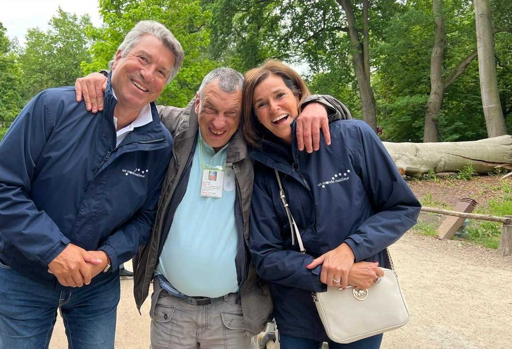Patrick et Donatienne rient bras dessus bras dessous avec une autre personne, pendant une sortie dans un parc